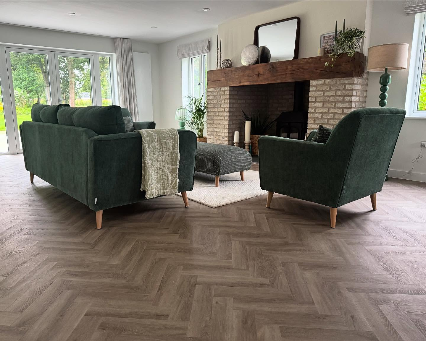 Herringbone LVT living room with green sofas