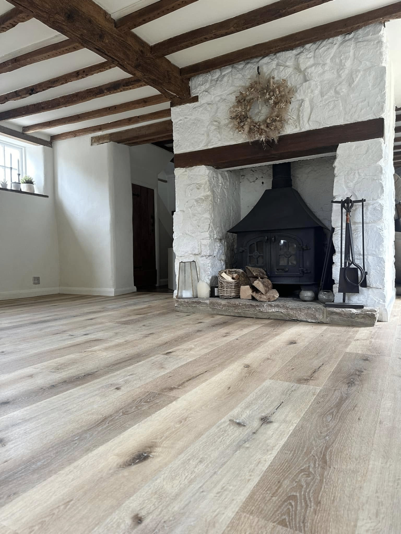 Rustic oak planks in beamed cottage