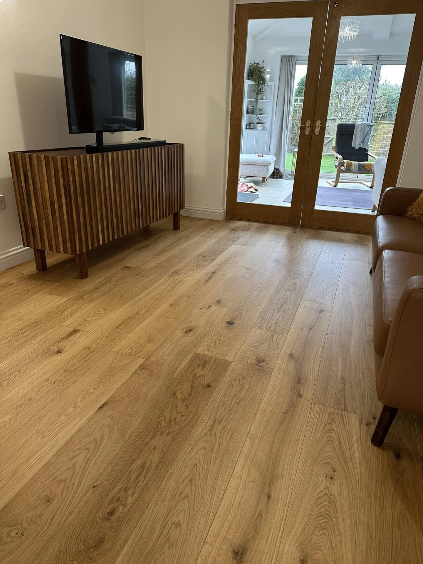 Oak plank living room with TV unit and glazed doors